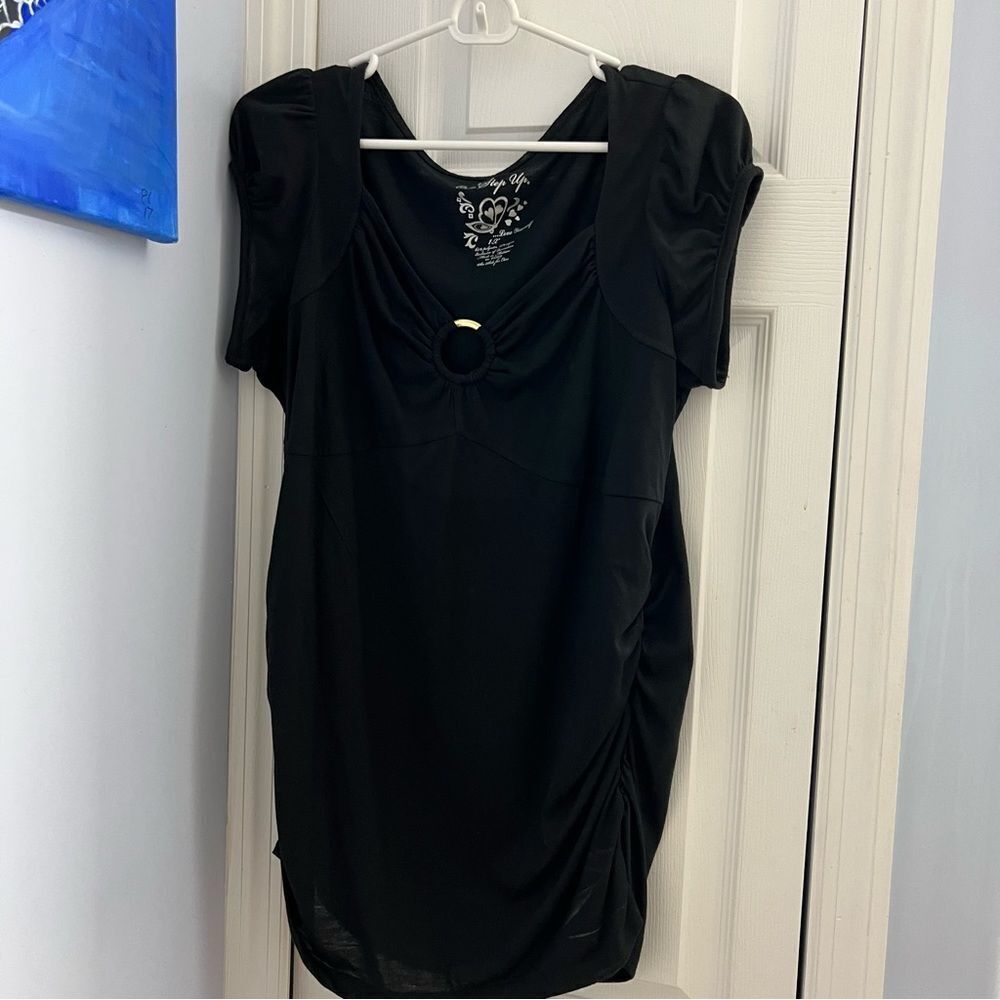Black long blouse with gold ring in center.